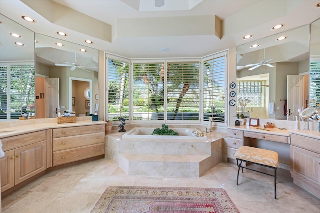 bathroom with vanity, a relaxing tiled tub, tile patterned floors, and ceiling fan