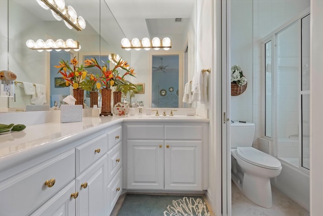 full bathroom featuring toilet, combined bath / shower with glass door, vanity, and ceiling fan