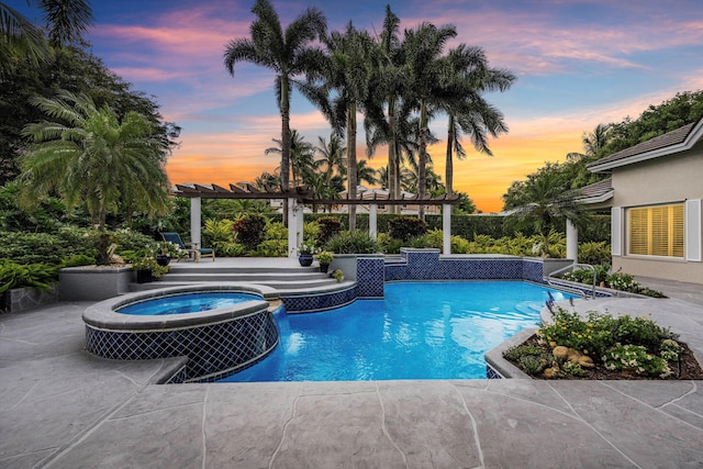 pool at dusk featuring an in ground hot tub, a pergola, and a patio