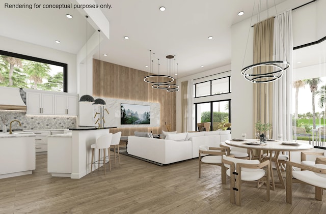 interior space featuring sink, light hardwood / wood-style floors, and an inviting chandelier