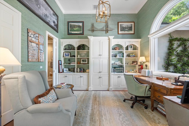 office with light hardwood / wood-style floors, crown molding, and a chandelier