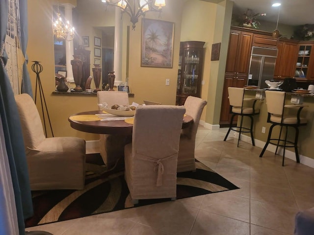 tiled dining space featuring a chandelier