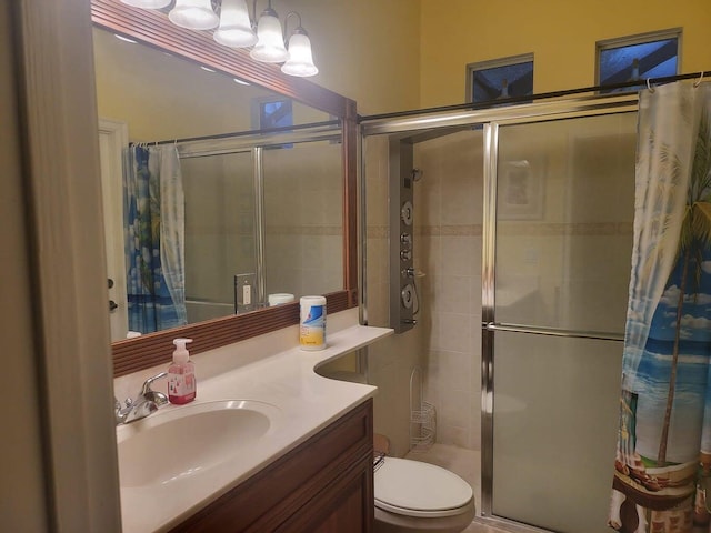 bathroom featuring toilet, vanity, and a shower with shower curtain