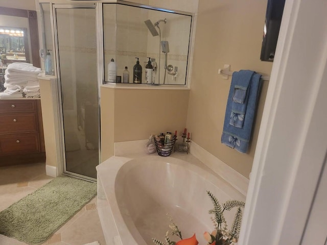 bathroom with plus walk in shower and tile patterned flooring