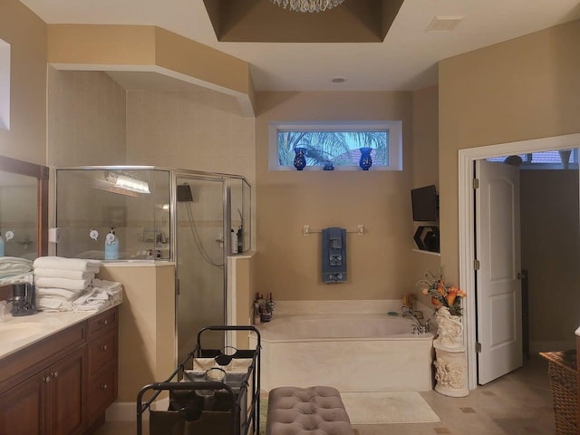 bathroom with vanity and separate shower and tub