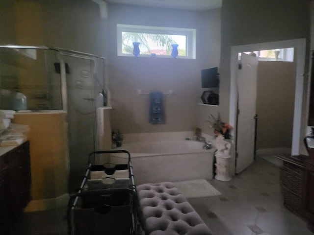 bathroom featuring vanity and shower with separate bathtub