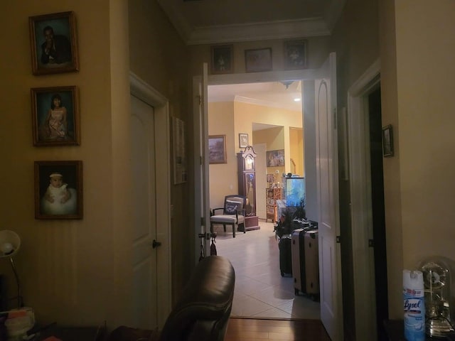 hall featuring light tile patterned floors and ornamental molding