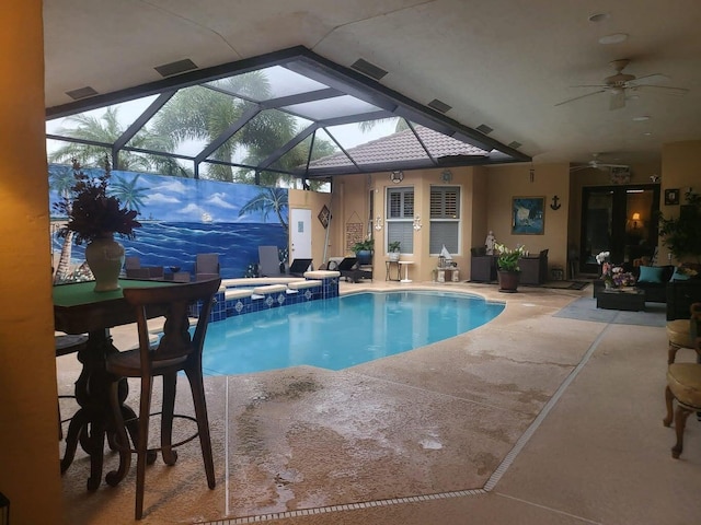 view of pool with a patio area, an in ground hot tub, ceiling fan, and glass enclosure