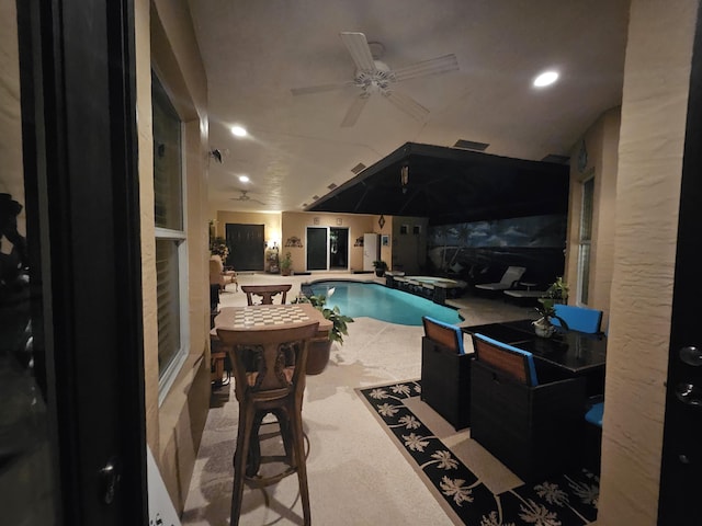 view of pool featuring ceiling fan and an in ground hot tub