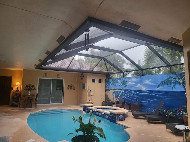 view of pool featuring an in ground hot tub, a patio area, and a lanai