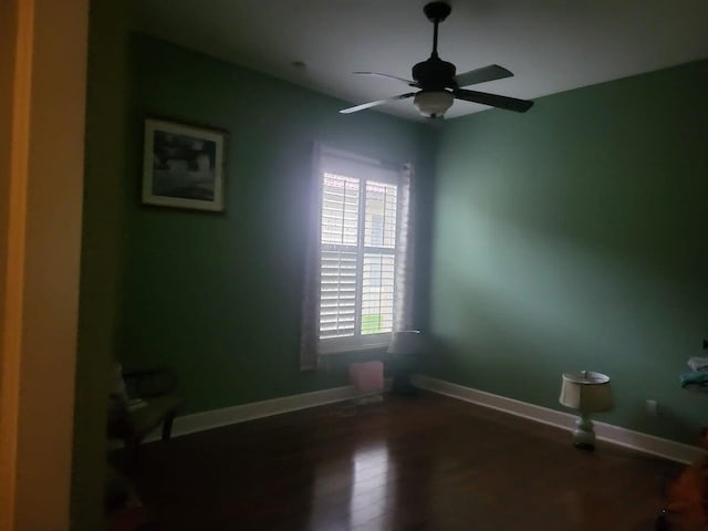 spare room with ceiling fan and dark wood-type flooring