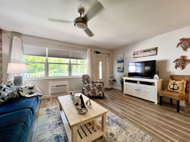 living room featuring wood-type flooring, ceiling fan, and a wall mounted AC