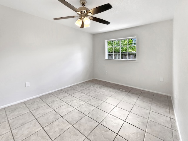 unfurnished room with light tile patterned floors and ceiling fan