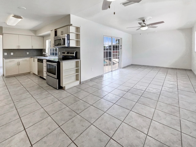 kitchen featuring backsplash, stainless steel appliances, ceiling fan, white cabinets, and light tile patterned flooring