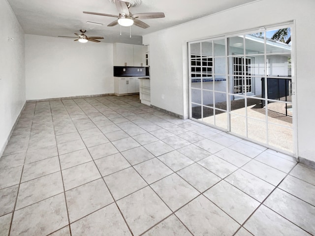 unfurnished living room featuring light tile patterned floors and ceiling fan