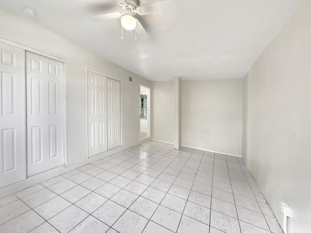 tiled empty room featuring ceiling fan