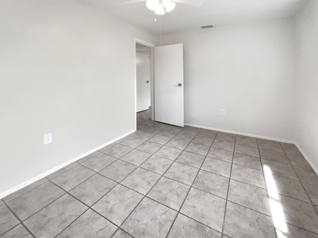 unfurnished room with light tile patterned floors and ceiling fan