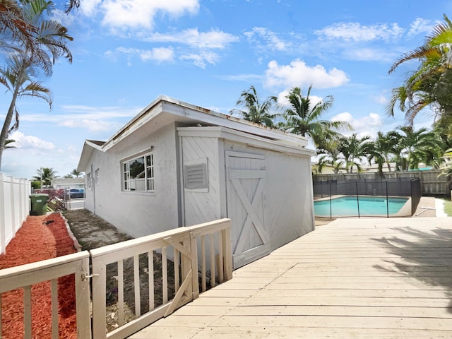 exterior space featuring a fenced in pool and a shed