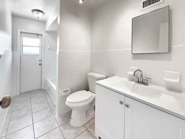 full bathroom with tile patterned flooring, toilet, tile walls, shower / bath combination, and vanity