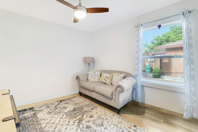 living area with ceiling fan and hardwood / wood-style flooring