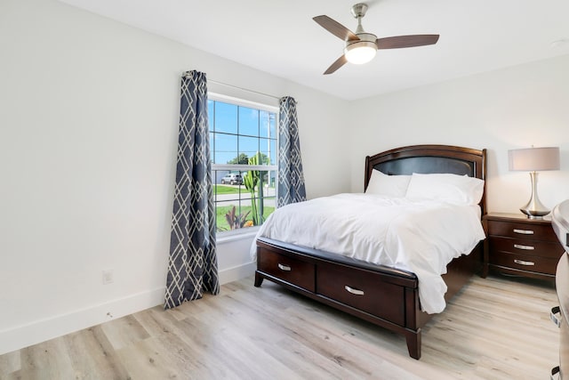 bedroom with light hardwood / wood-style flooring and ceiling fan