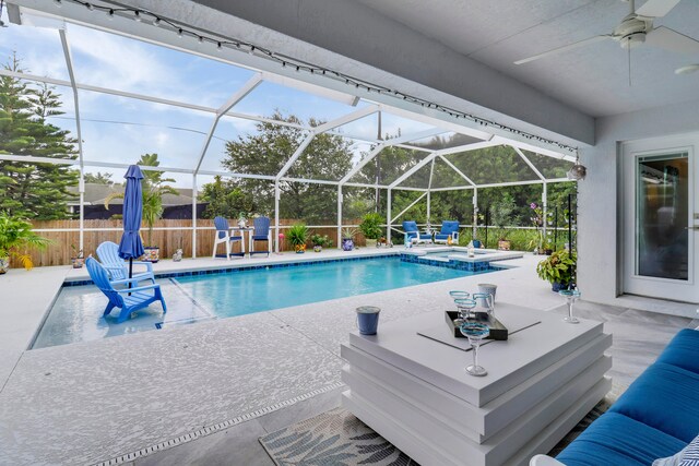 view of pool featuring a lanai, ceiling fan, and a patio