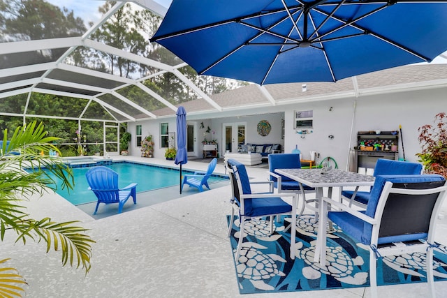 view of pool with a lanai, french doors, ceiling fan, and a patio area