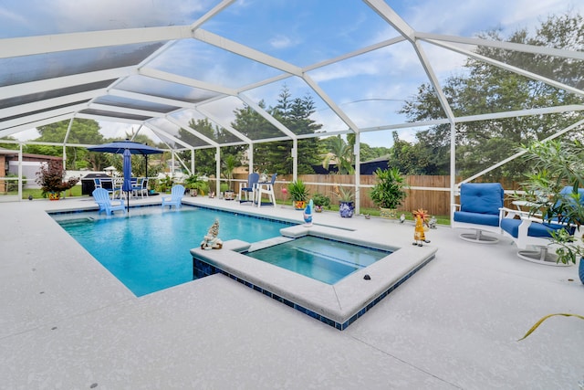 view of pool featuring a lanai, an in ground hot tub, and a patio