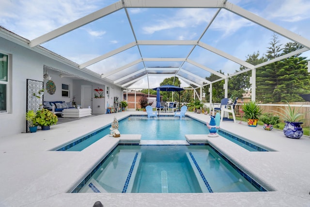 view of swimming pool featuring a lanai, an in ground hot tub, and a patio