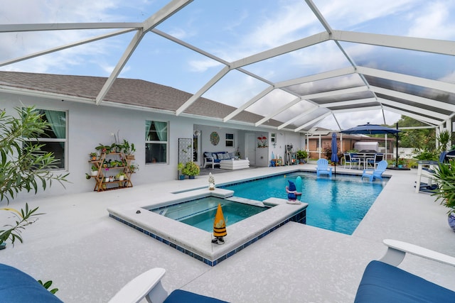 view of swimming pool featuring a lanai, a patio area, and an in ground hot tub