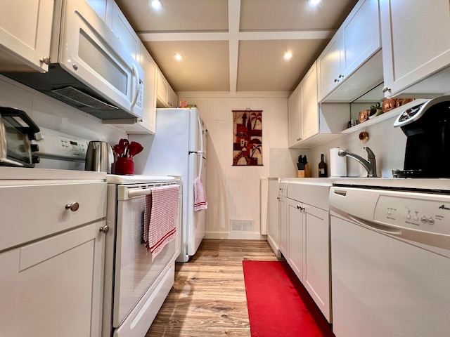 kitchen featuring white appliances, light wood-type flooring, and white cabinetry