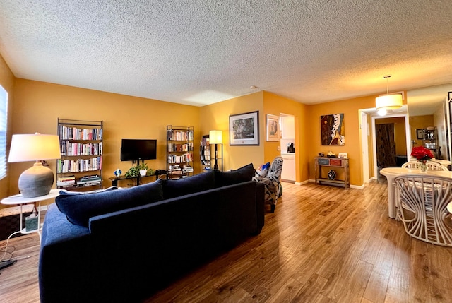 living room featuring hardwood / wood-style floors and a textured ceiling