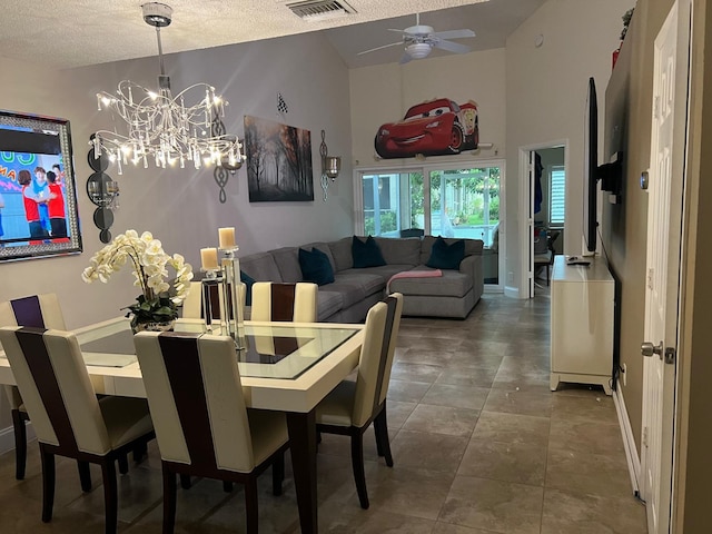 dining space with ceiling fan with notable chandelier, vaulted ceiling, and a textured ceiling