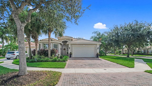 mediterranean / spanish-style house with a garage and a front yard