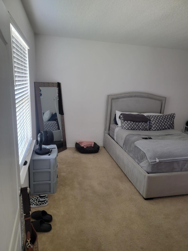 carpeted bedroom featuring a textured ceiling