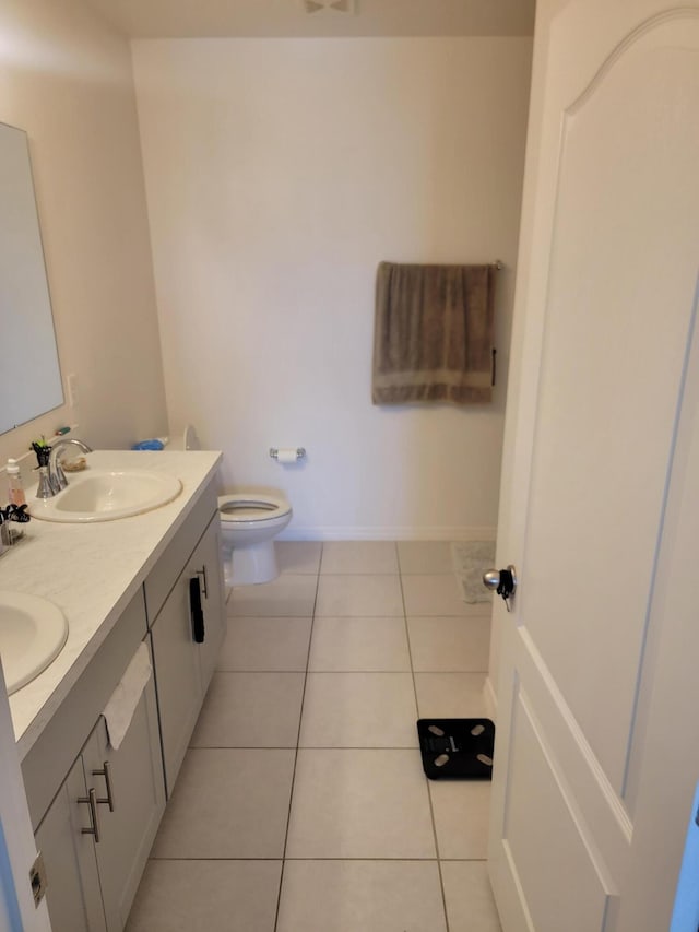 bathroom with vanity, toilet, and tile patterned floors