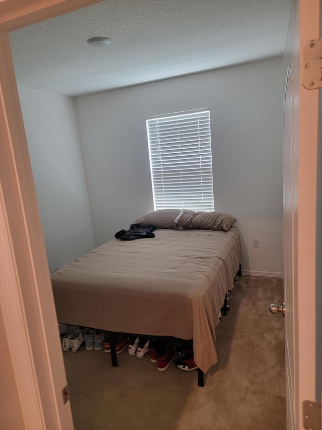 carpeted bedroom with a textured ceiling