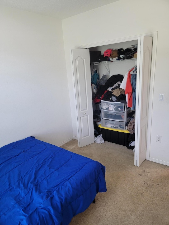 carpeted bedroom with a closet