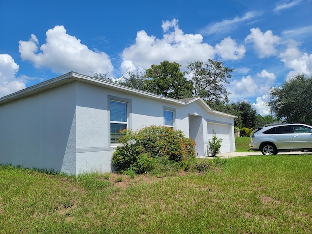 view of home's exterior featuring a garage and a lawn