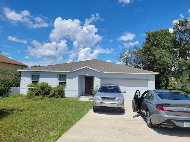 single story home featuring a garage and a front yard