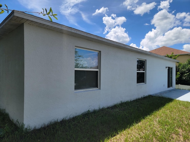 view of side of property with a lawn