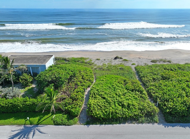 birds eye view of property with a view of the beach and a water view