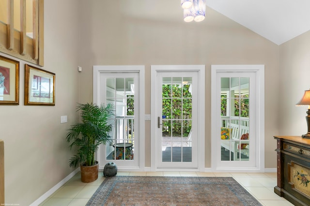 doorway featuring lofted ceiling and light tile patterned flooring