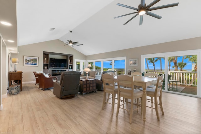 dining room featuring high vaulted ceiling, light wood-type flooring, and ceiling fan