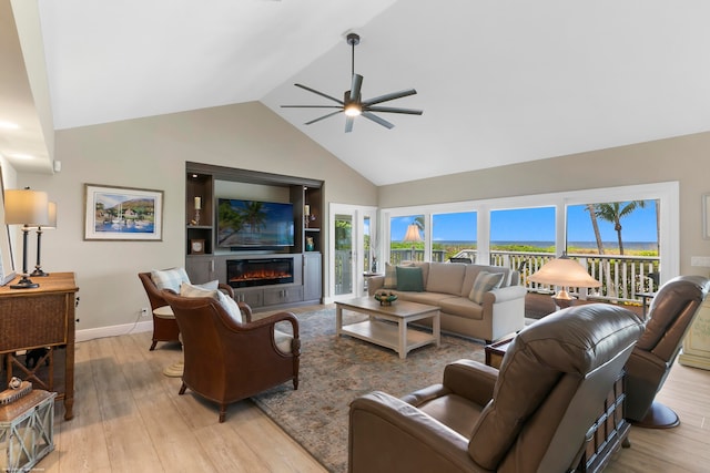 living room featuring light hardwood / wood-style floors, high vaulted ceiling, and ceiling fan