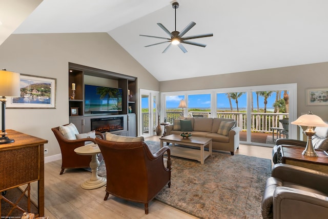 living room featuring high vaulted ceiling, light wood-type flooring, and ceiling fan