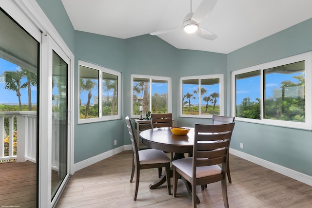 interior space with lofted ceiling, ceiling fan, light wood-type flooring, and a wealth of natural light