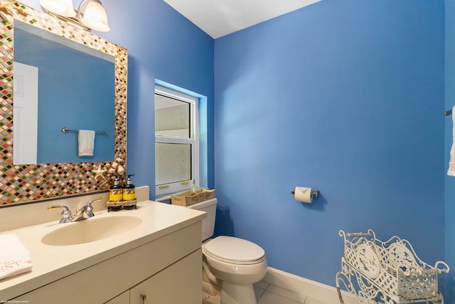 bathroom featuring vanity, toilet, and tile patterned flooring