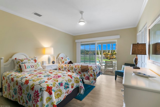 bedroom featuring ornamental molding, light hardwood / wood-style flooring, and access to outside