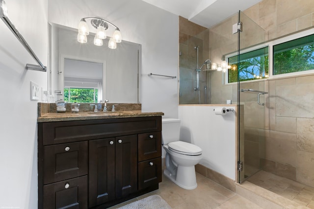 bathroom featuring vanity, toilet, walk in shower, and tile patterned flooring